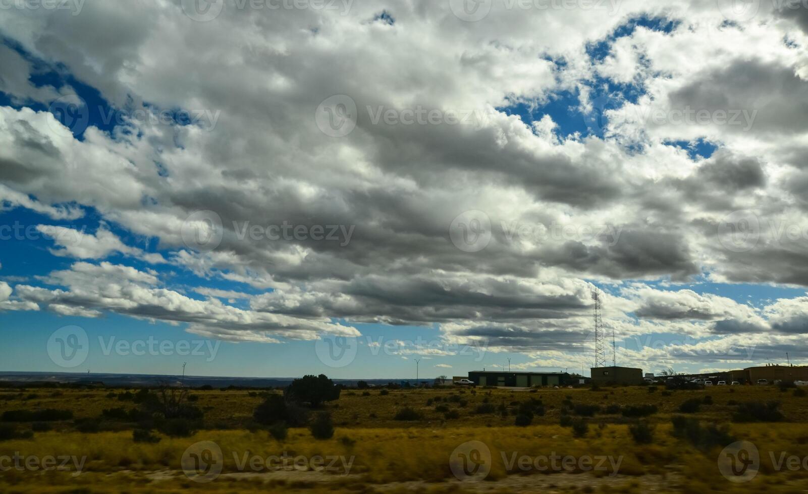 Large white clouds over a desert in the state of New Mexico, USA photo