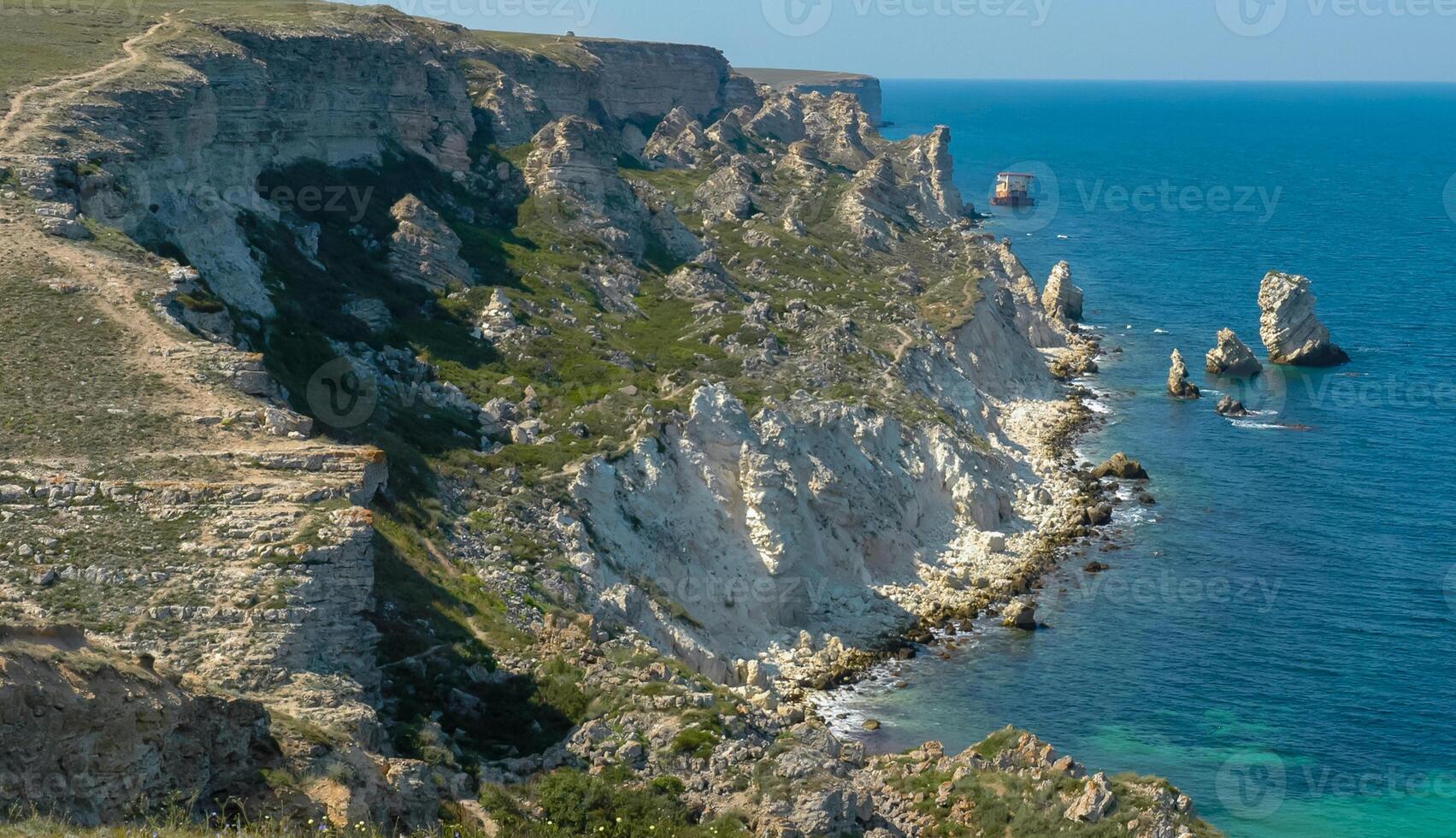 View of the steep banks and rocks in the water in the Dzhangul tract, western Crimea photo