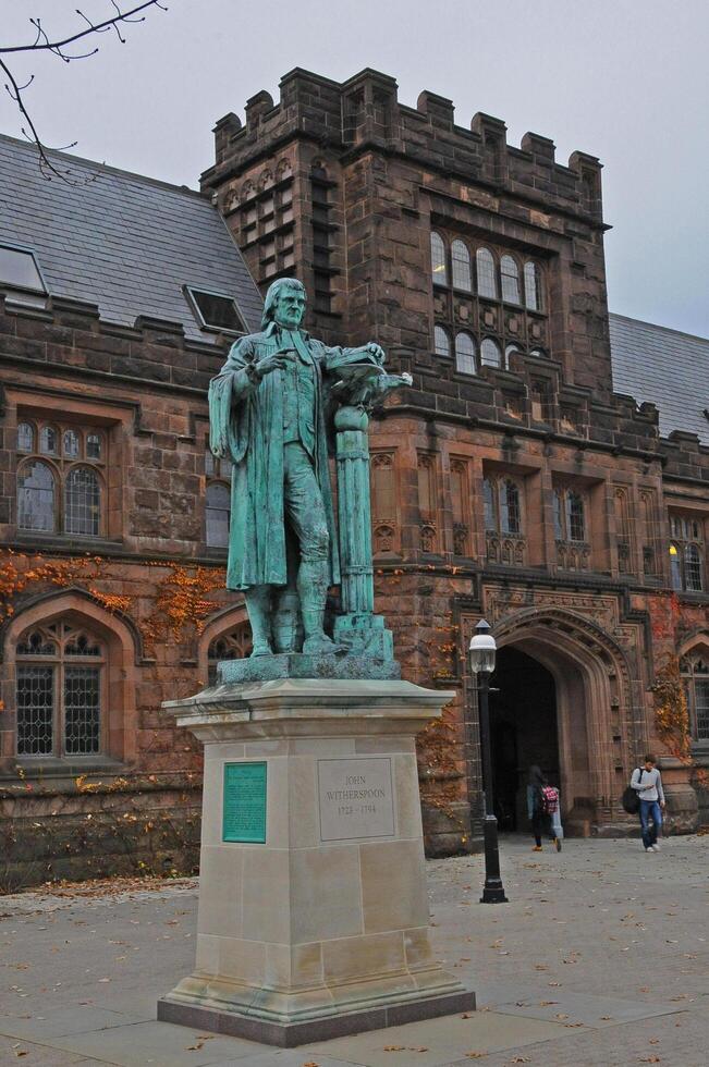 PRINCETON, NJ -15 NOVEMBER 2011 View of the facade of East Pyne Building and a statue of Princeton University President John Witherspoon on the Princeton University campus, New Jersey, USA photo