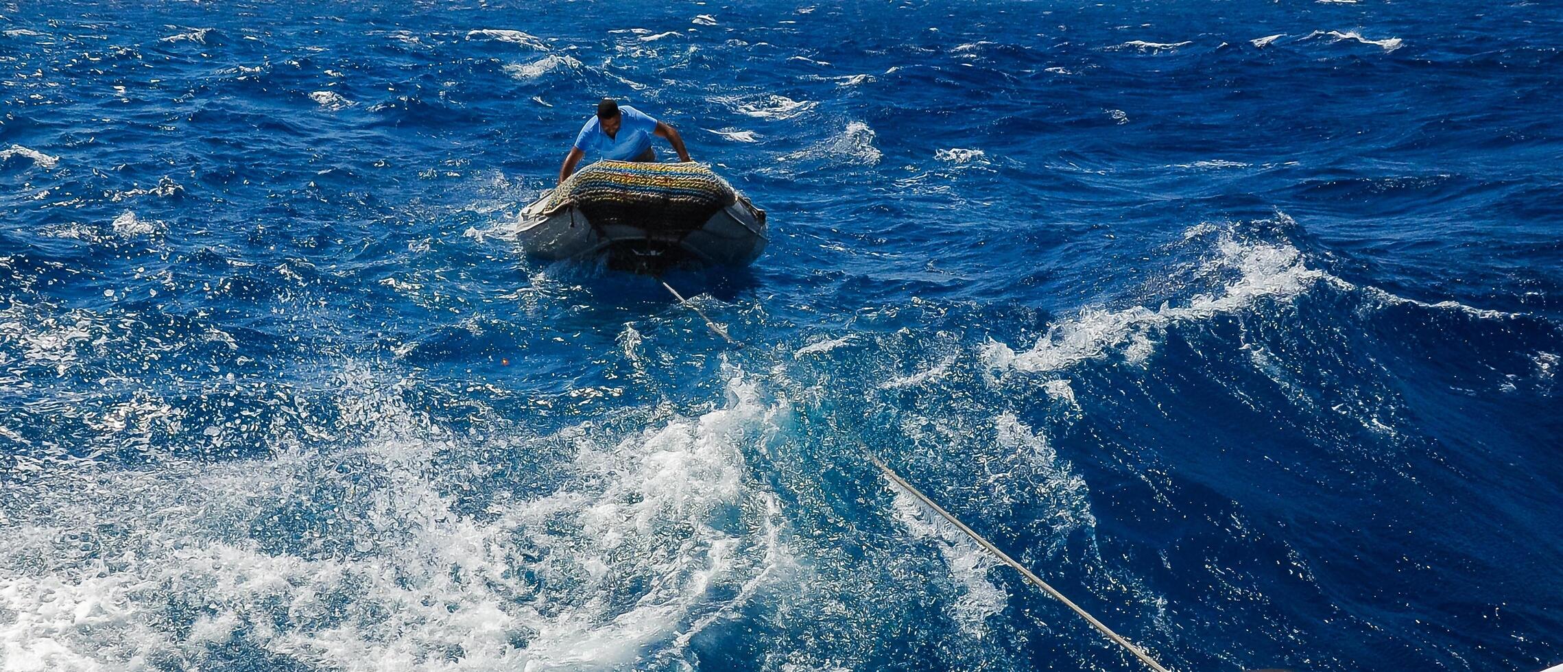 Egyptian on an inflatable rubber boat providing diving in the Red Sea photo