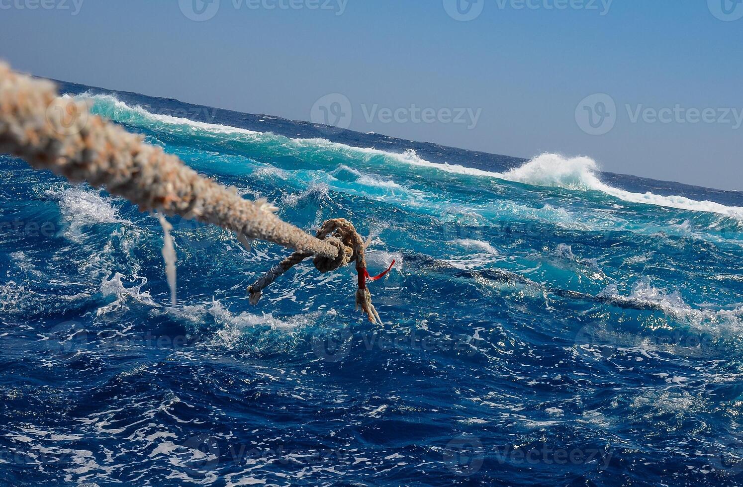 Mooring with a thick rope to the Big Brother island of a diving yacht during a storm photo