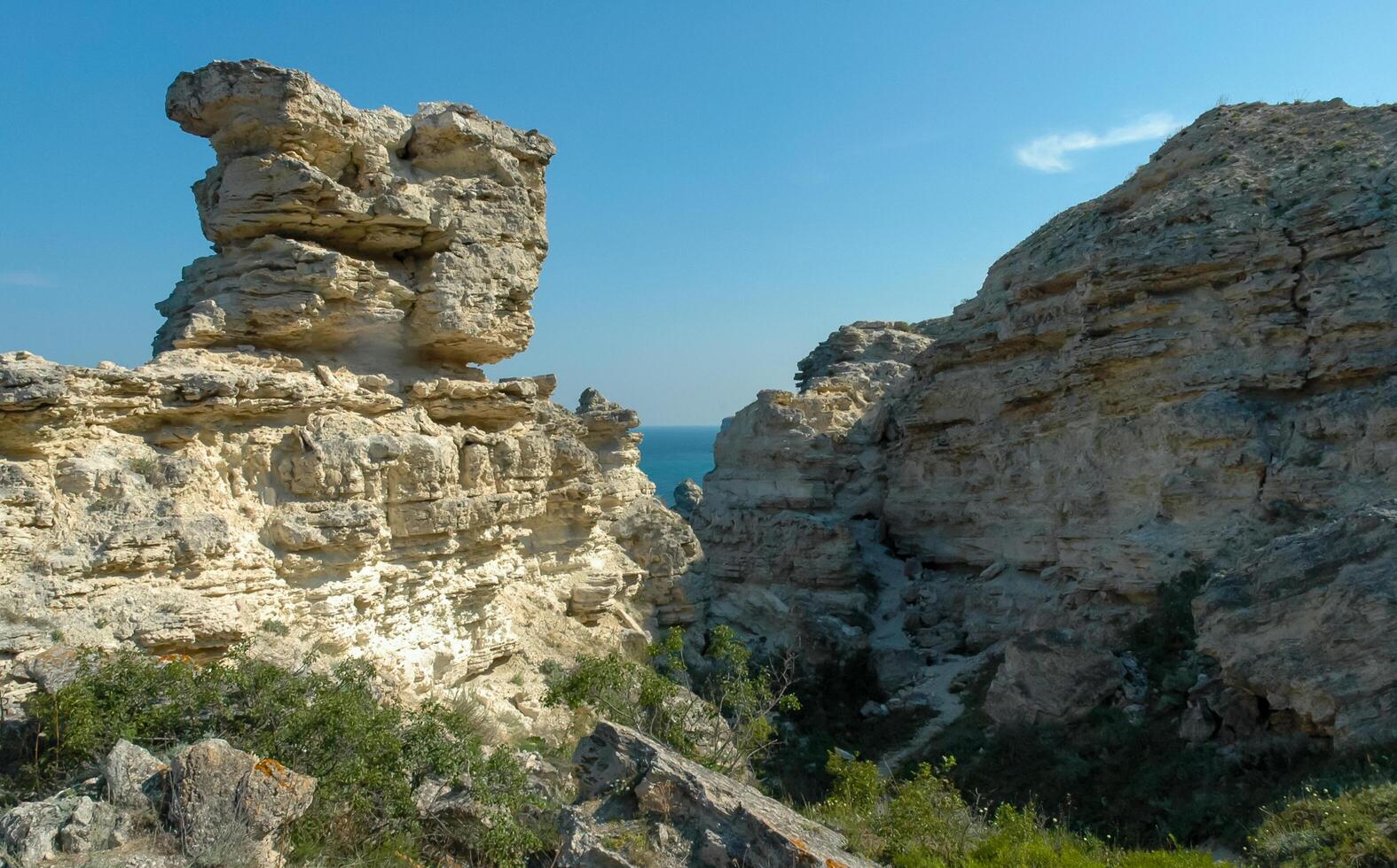 View of the steep banks and rocks in the water in the Dzhangul tract, western Crimea photo
