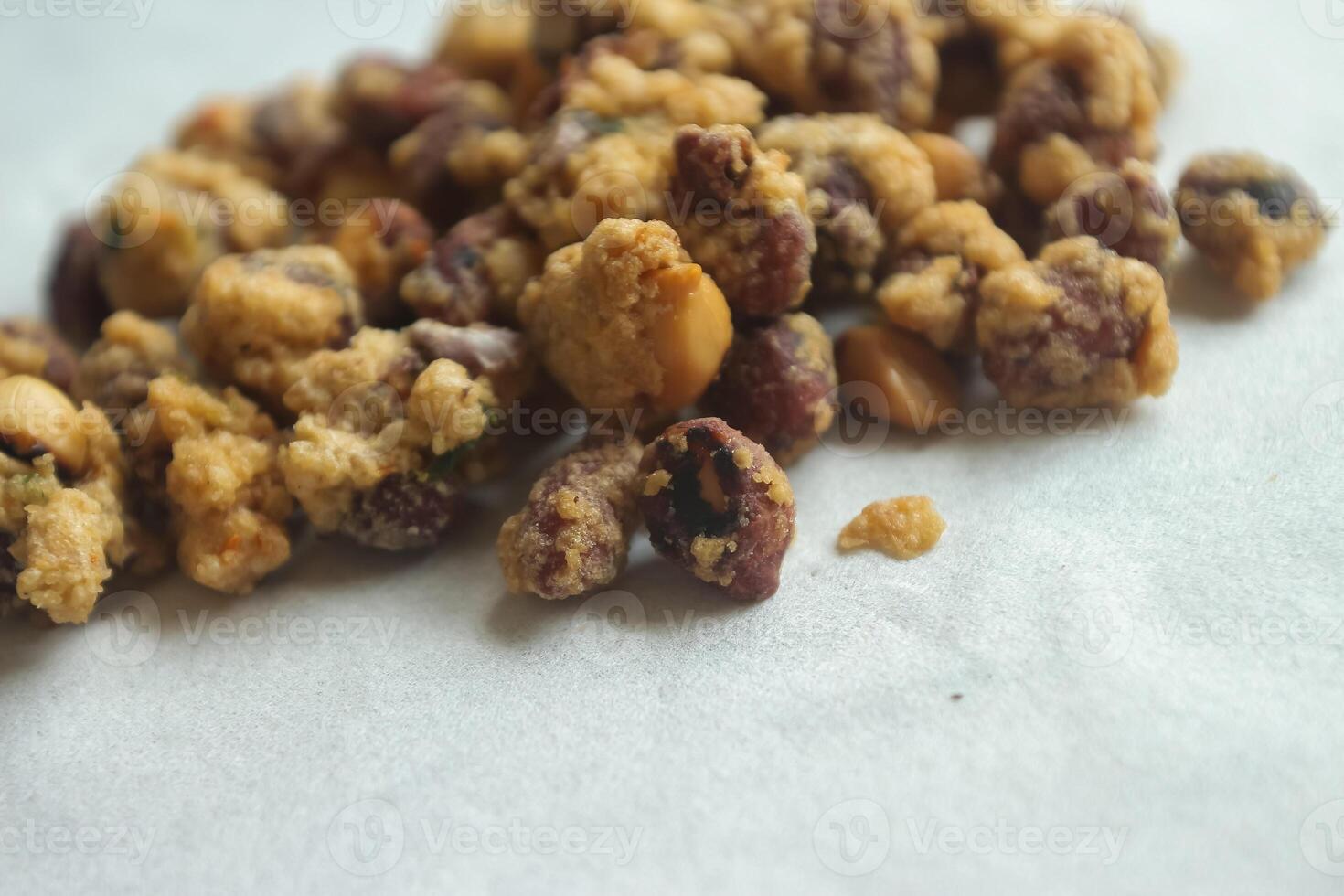 A delicious Indonesian peanut snack. Egg Nuts are nuts wrapped in wheat flour, eggs and ground spices, fried, with a curly texture, with a crunchy, crunchy and tasty taste. photo