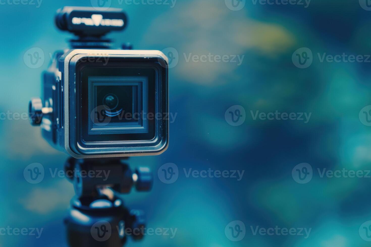 Elegant camera resting on a tripod, framed against a serene underwater background, capturing the tranquility of the deep ocean at midday photo
