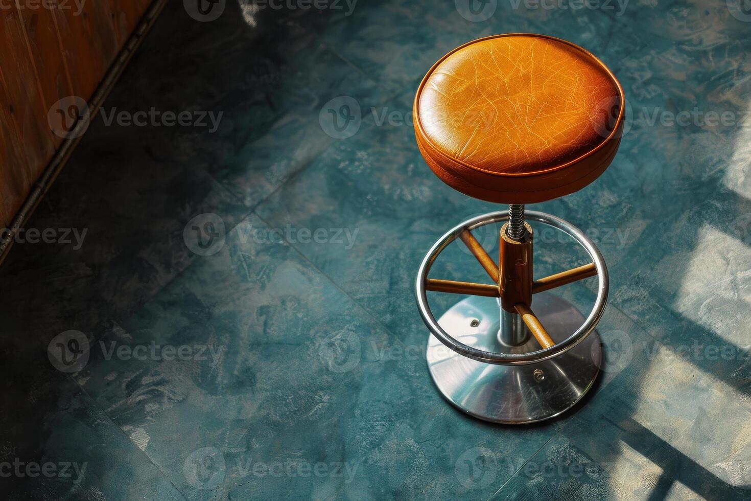 A solitary bar stool basking in afternoon sunlight on a patterned floor photo