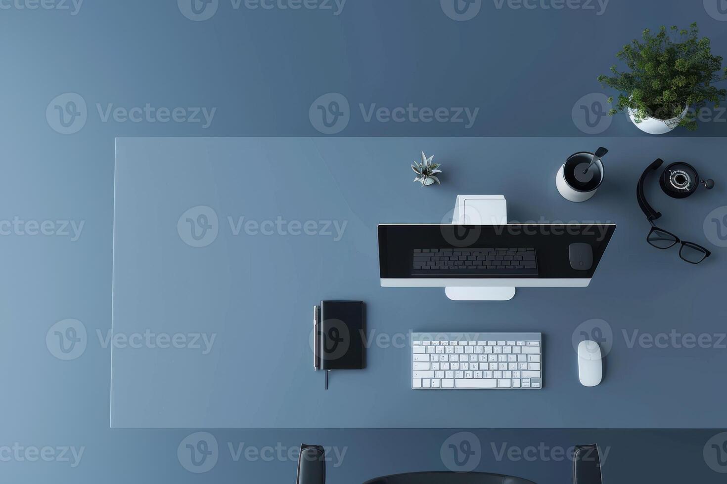 Modern workspace with minimalistic design and technological essentials in a serene blue setting photo