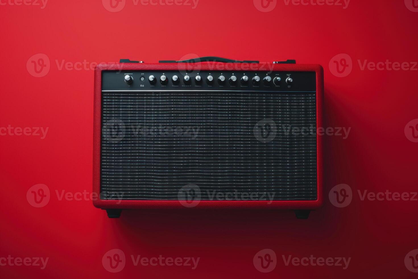 A vibrant red guitar amplifier against a matching backdrop in a minimalist studio setting photo