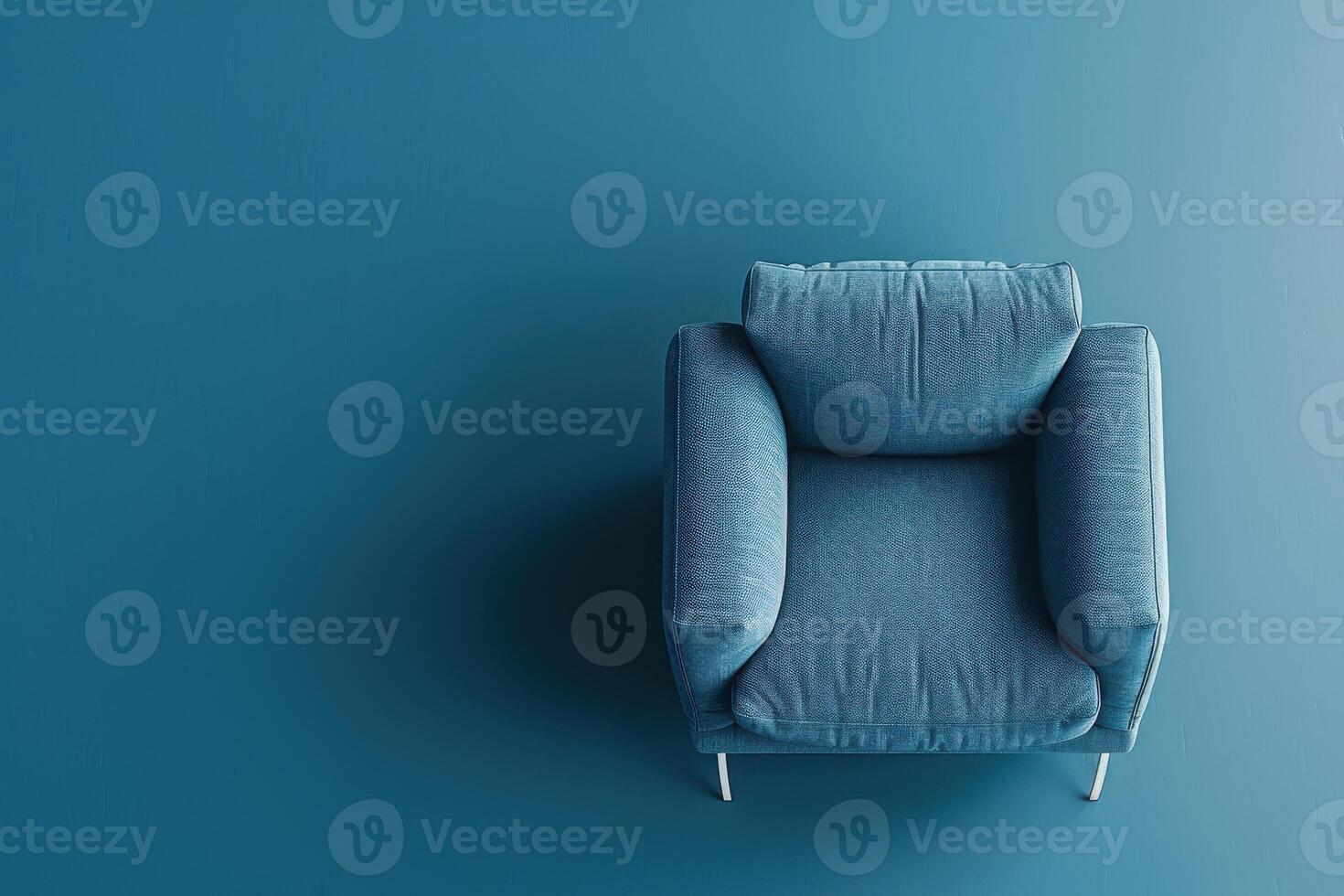 Soft blue armchair resting against a matching wall in a minimalist interior design setting photo