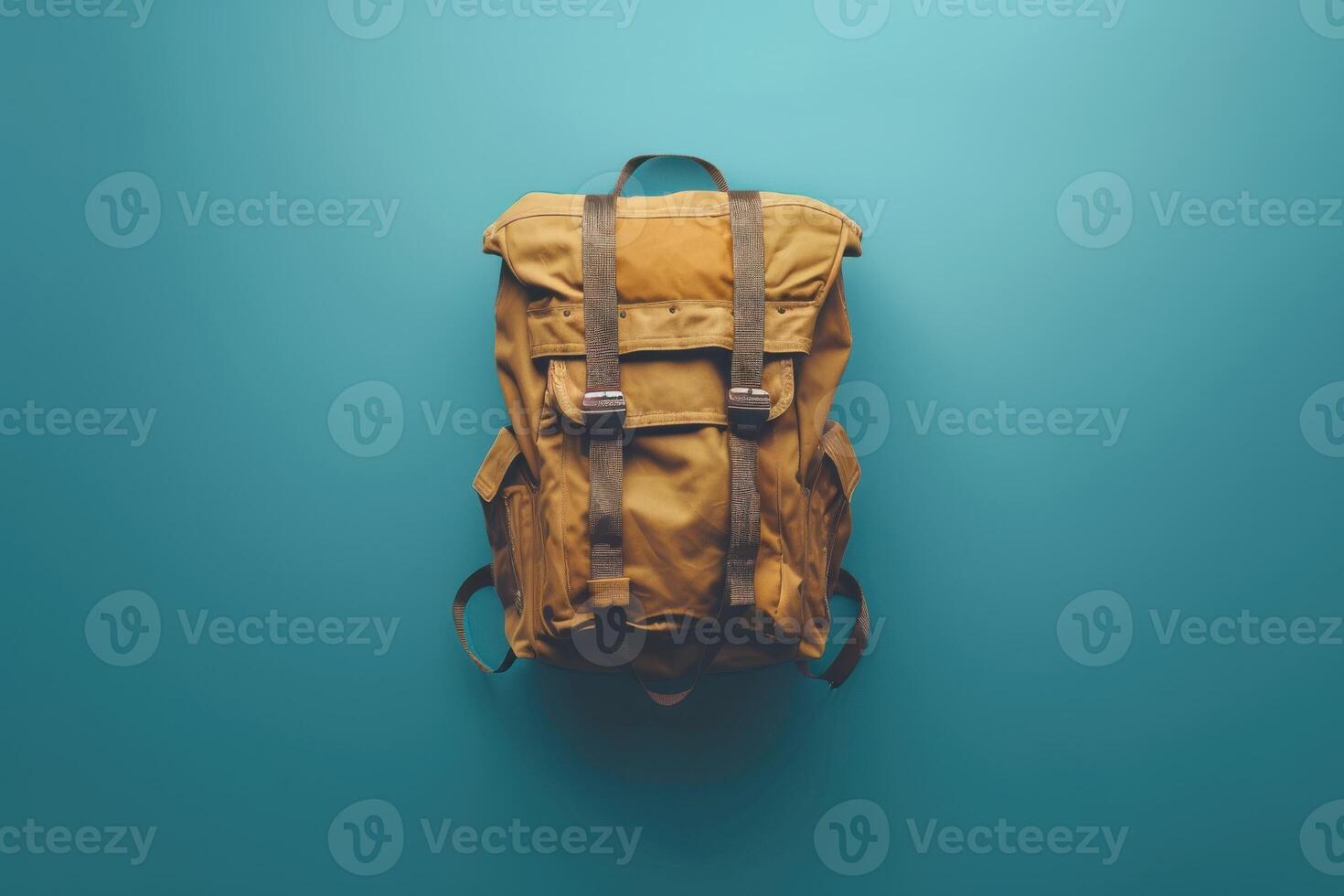 A rugged backpack resting on a vibrant blue surface, inviting adventure and exploration under soft, natural lighting photo