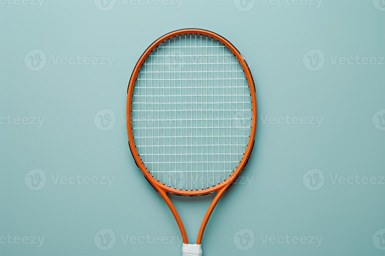 A vibrant orange tennis racket rests on a soft blue surface, capturing the essence of sport and leisure in this artistic arrangement photo