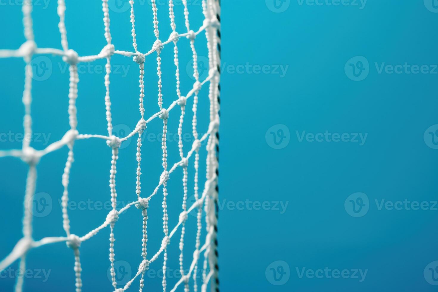 A close-up of a sports net against a vibrant blue background in a well-lit indoor arena photo