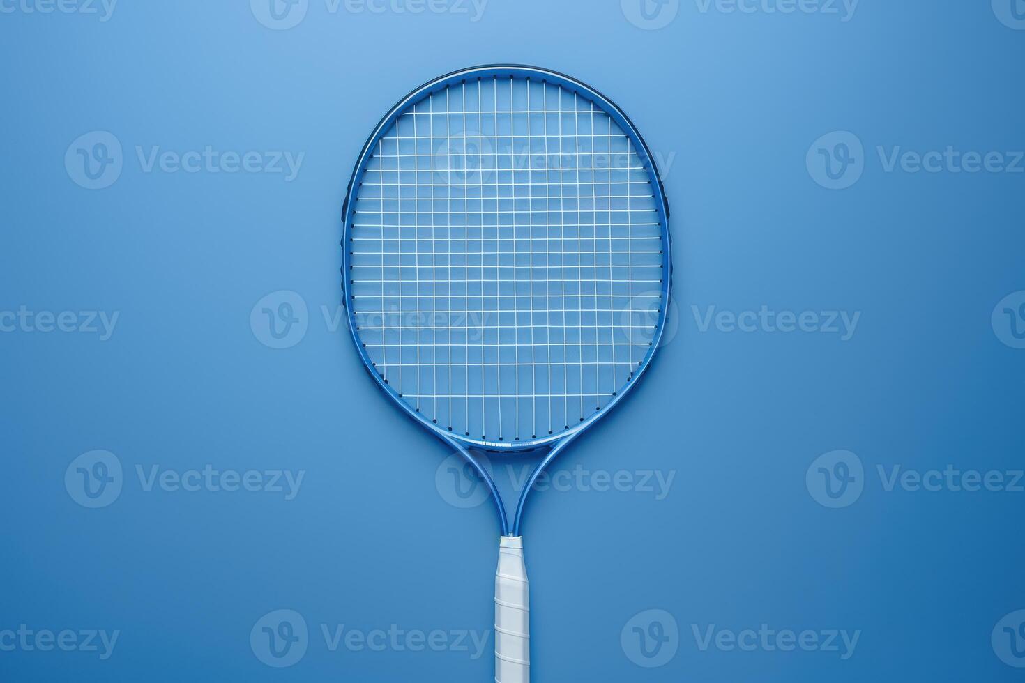 A vibrant blue tennis racket rests elegantly on a matching background, highlighting its design and craftsmanship photo