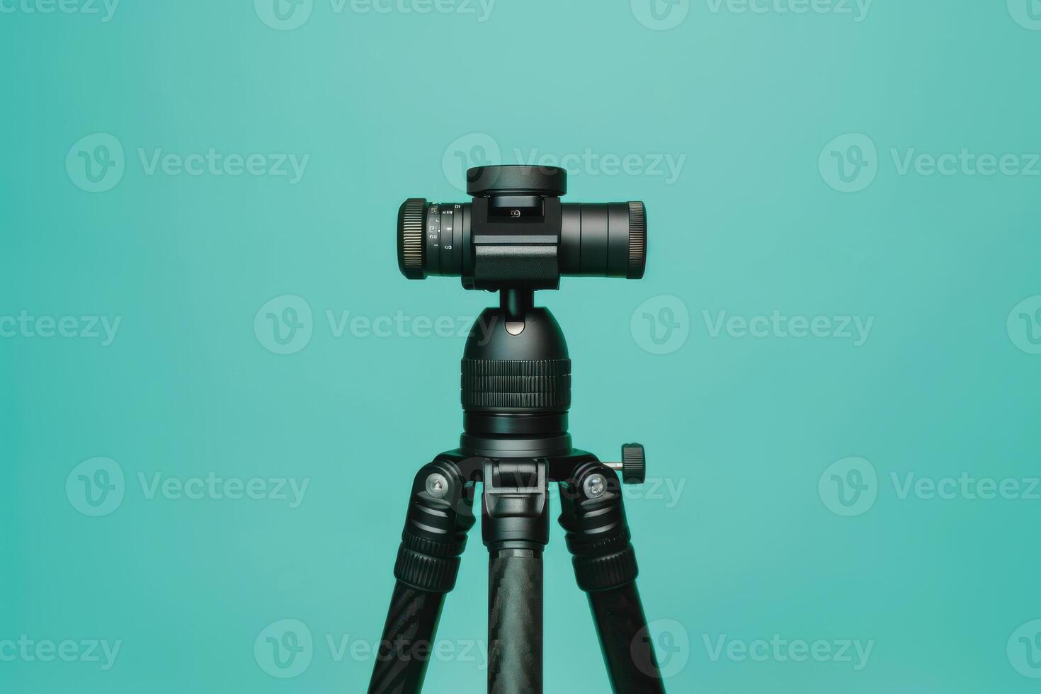 A sleek black tripod with a camera positioned against a vibrant turquoise backdrop, showcasing the perfect blend of technology and art photo