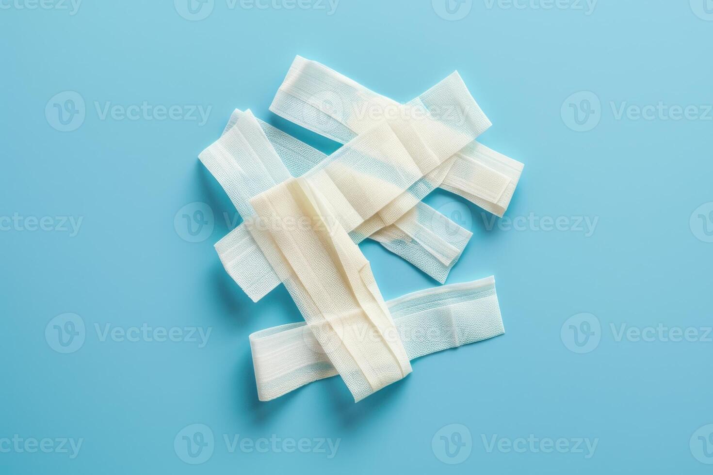 A collection of assorted bandages arranged playfully on a soft blue background, inviting healing and comfort photo