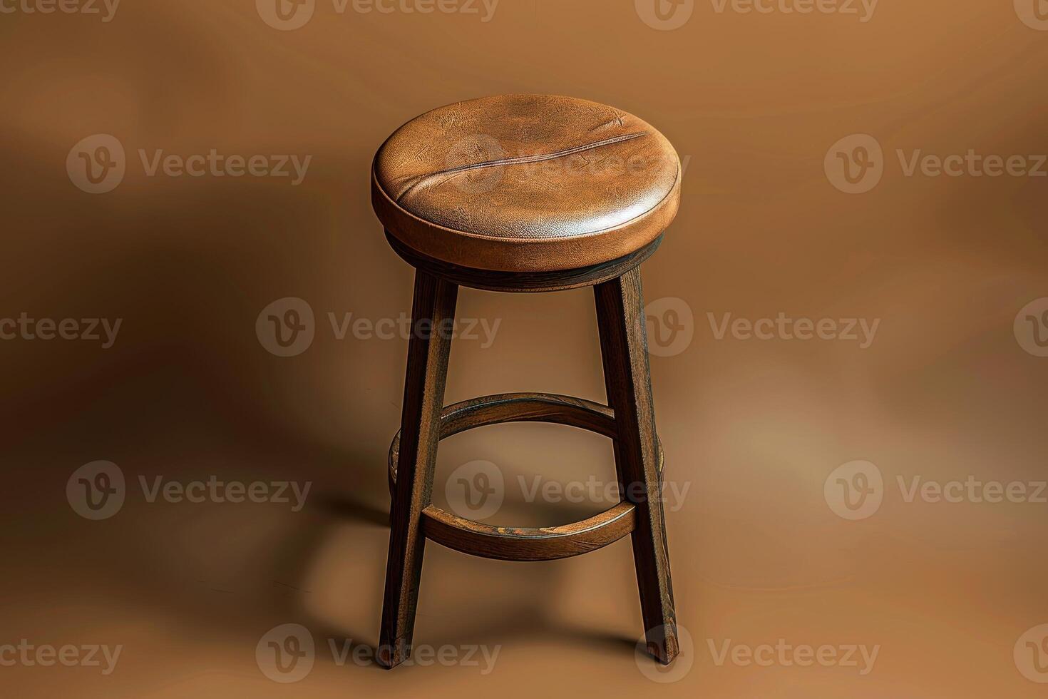 A rustic wooden stool with a plush leather seat against a warm, earthy backdrop in soft evening light photo