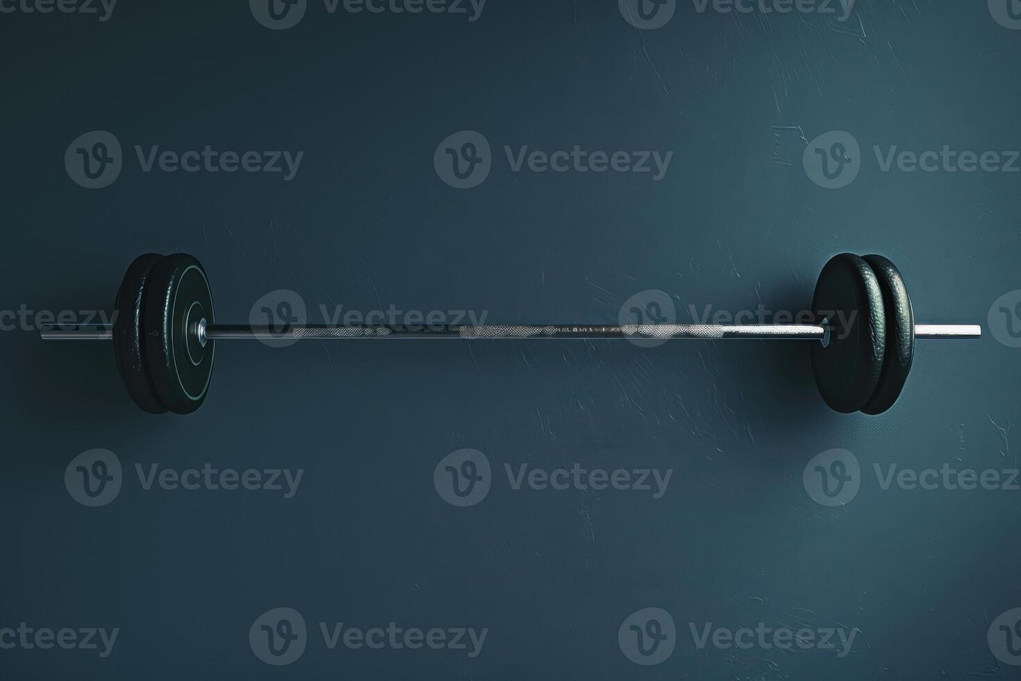 A heavy barbell resting on a blue background, awaiting the next workout session at dawn photo