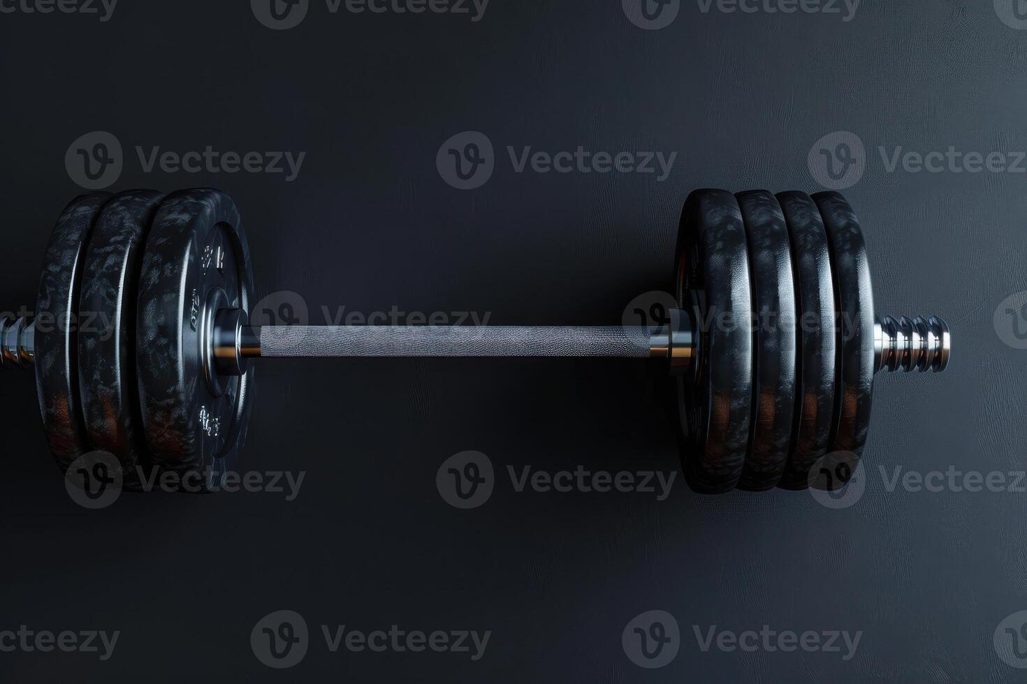 A powerful dumbbell rests on a dark surface, ready for a challenging workout session photo