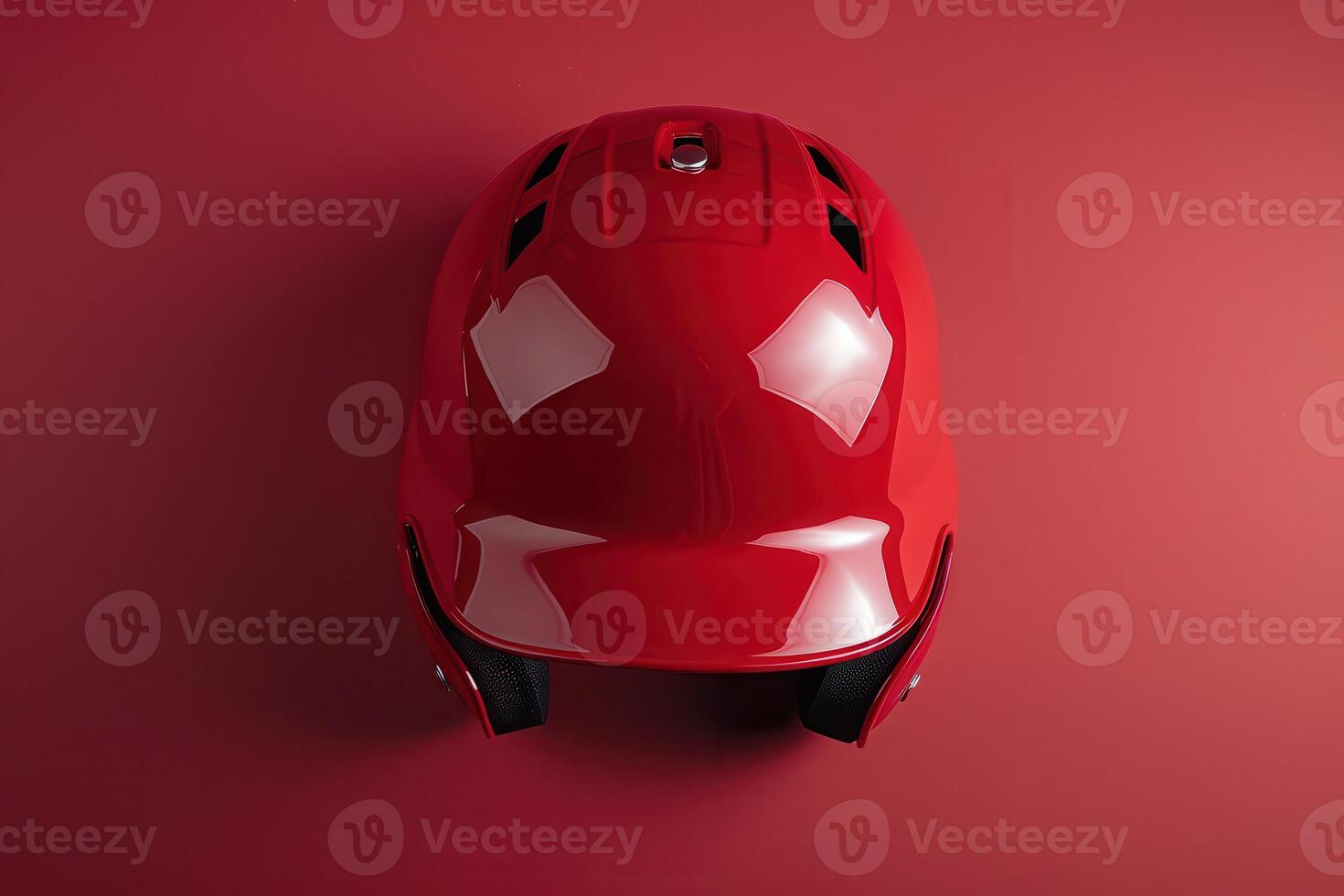 A vibrant red sports helmet displayed against a smooth crimson backdrop, showcasing its sleek design and protective features in a minimalist setting photo