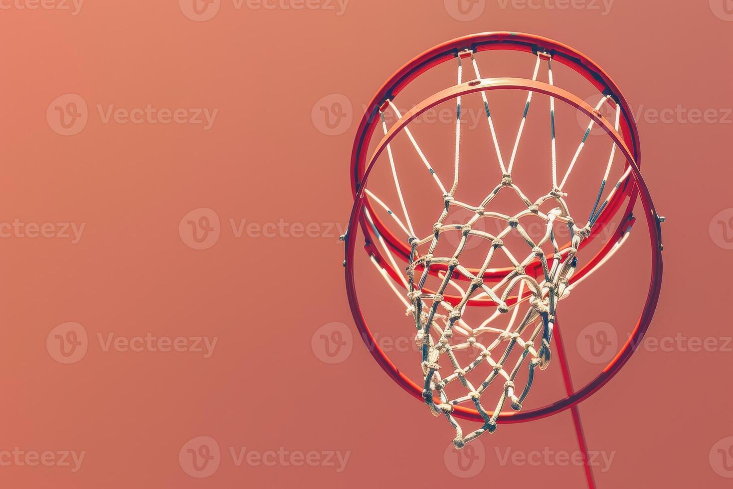 A vibrant basketball hoop against a warm sunset sky inviting play and passion in the heart of the city photo