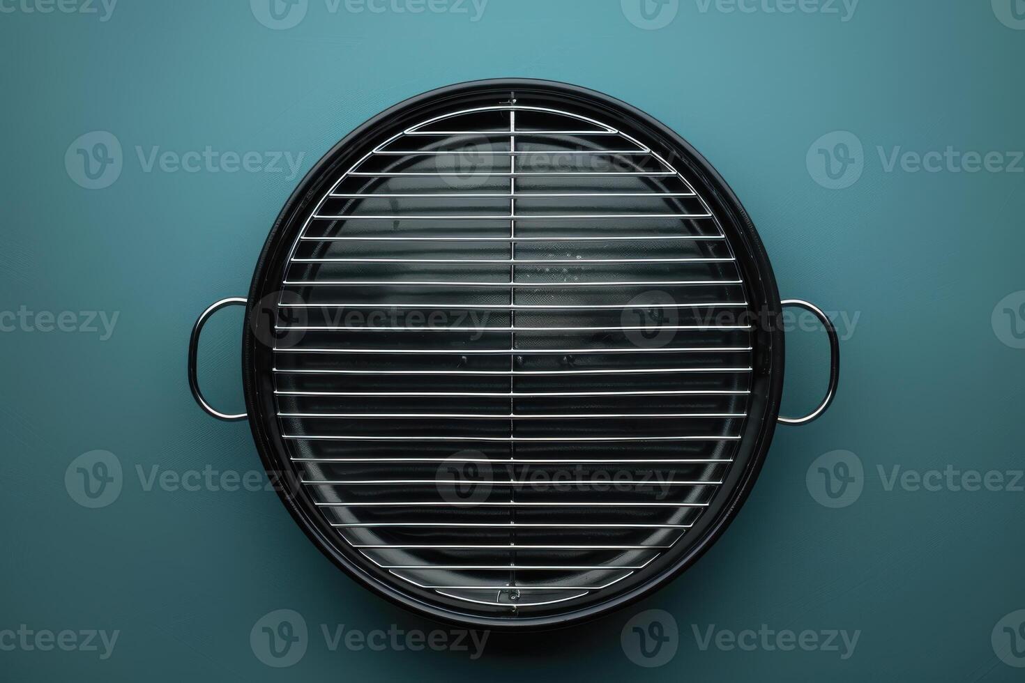 A stylish charcoal grill awaiting summer barbecues, set against a vibrant teal background, ready for outdoor gatherings photo
