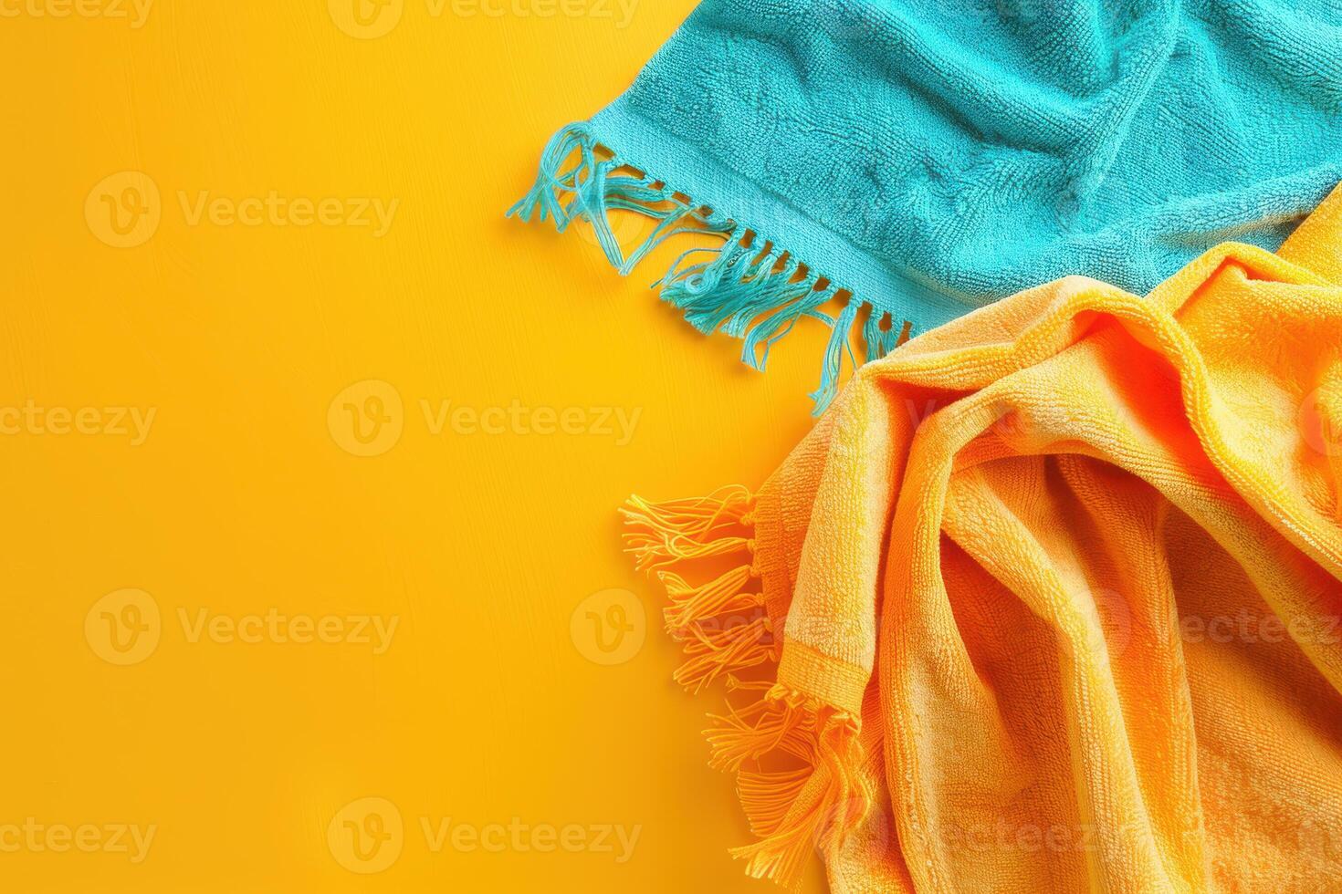 Two vibrant beach towels sprawled across a sunny yellow background, inviting relaxation and summer fun photo
