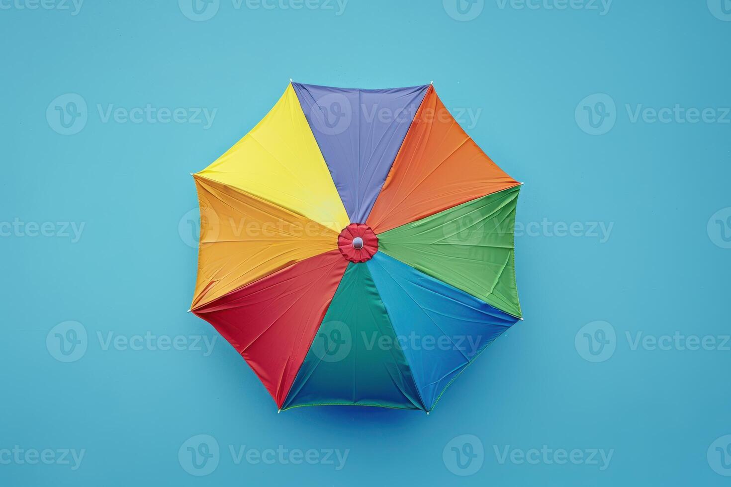 Colorful umbrella against a bright blue background during a sunny day in the park photo