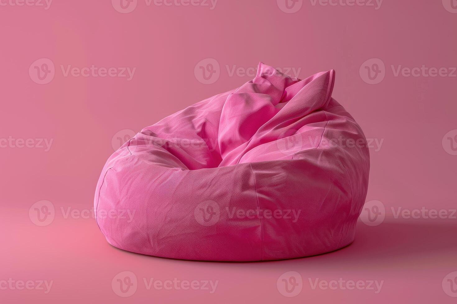 A cozy pink beanbag chair resting against a soft pastel backdrop in a modern living space photo