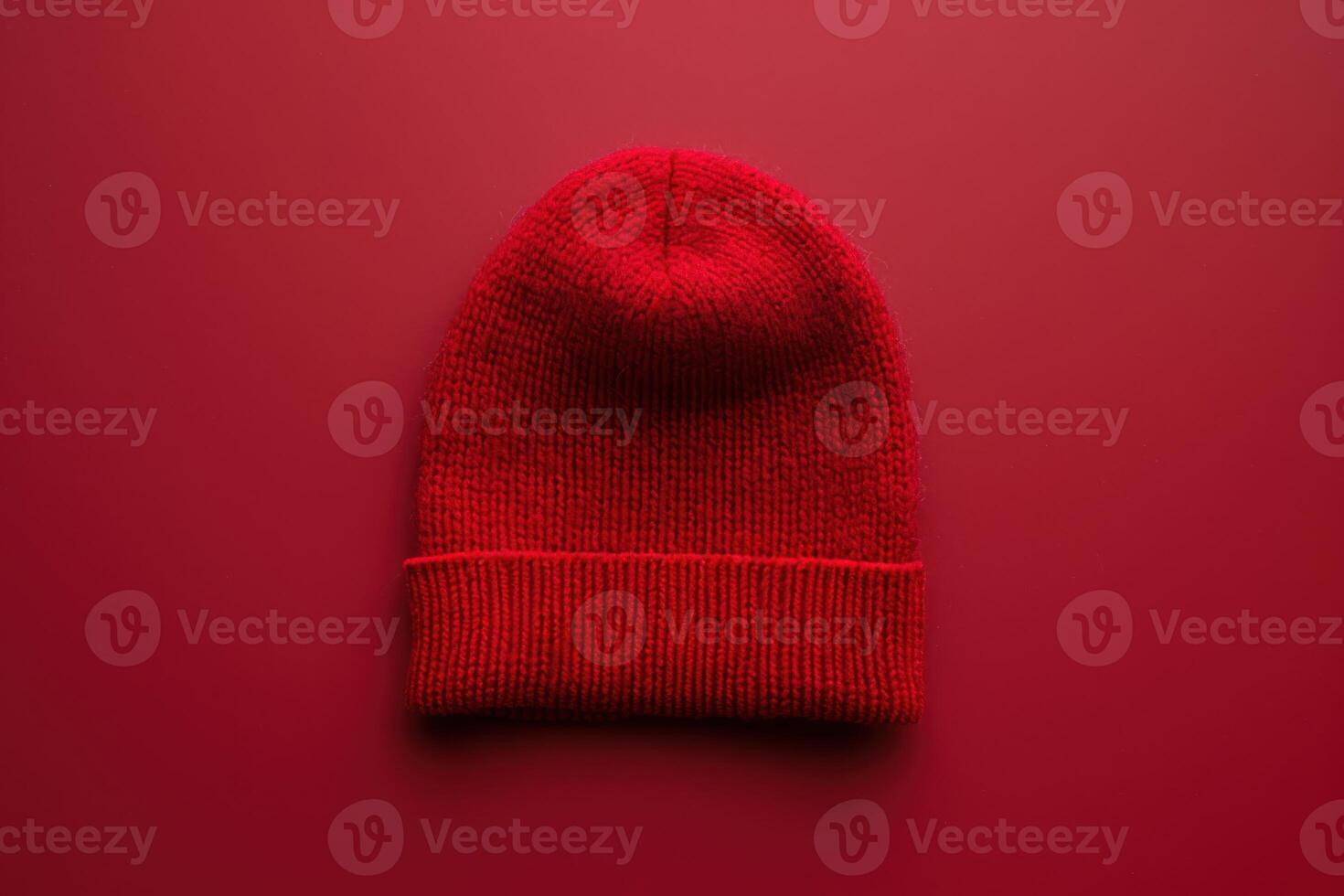 Vibrant red knit beanie on a matching backdrop, showcasing warmth and style in a minimalist aesthetic photo