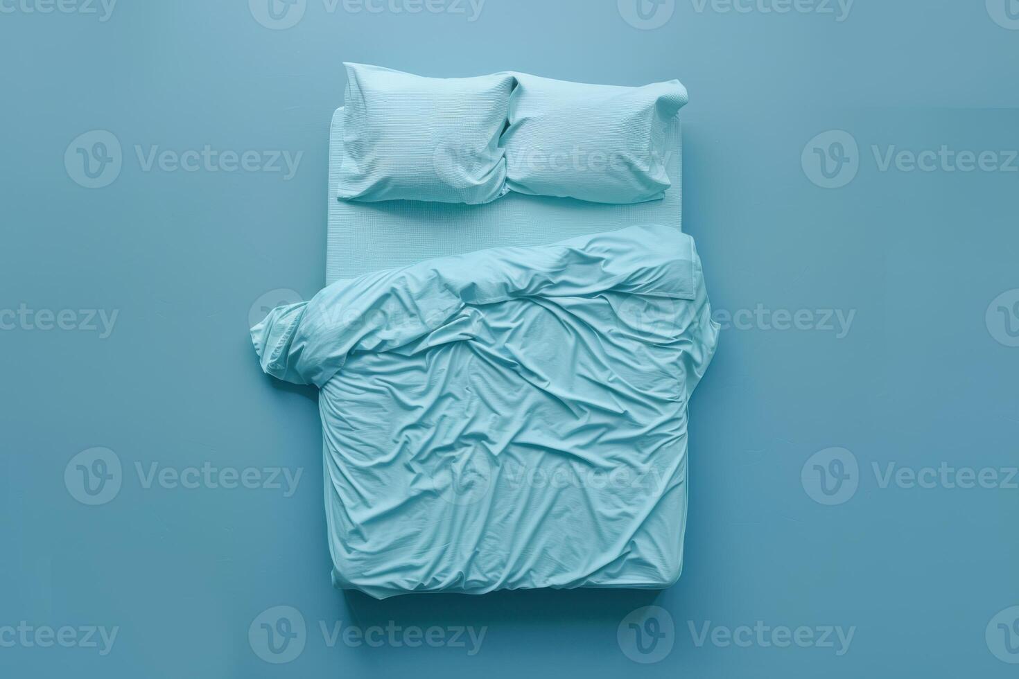 Light blue bedding arrangement with crumpled sheets in a serene bedroom on a quiet afternoon photo