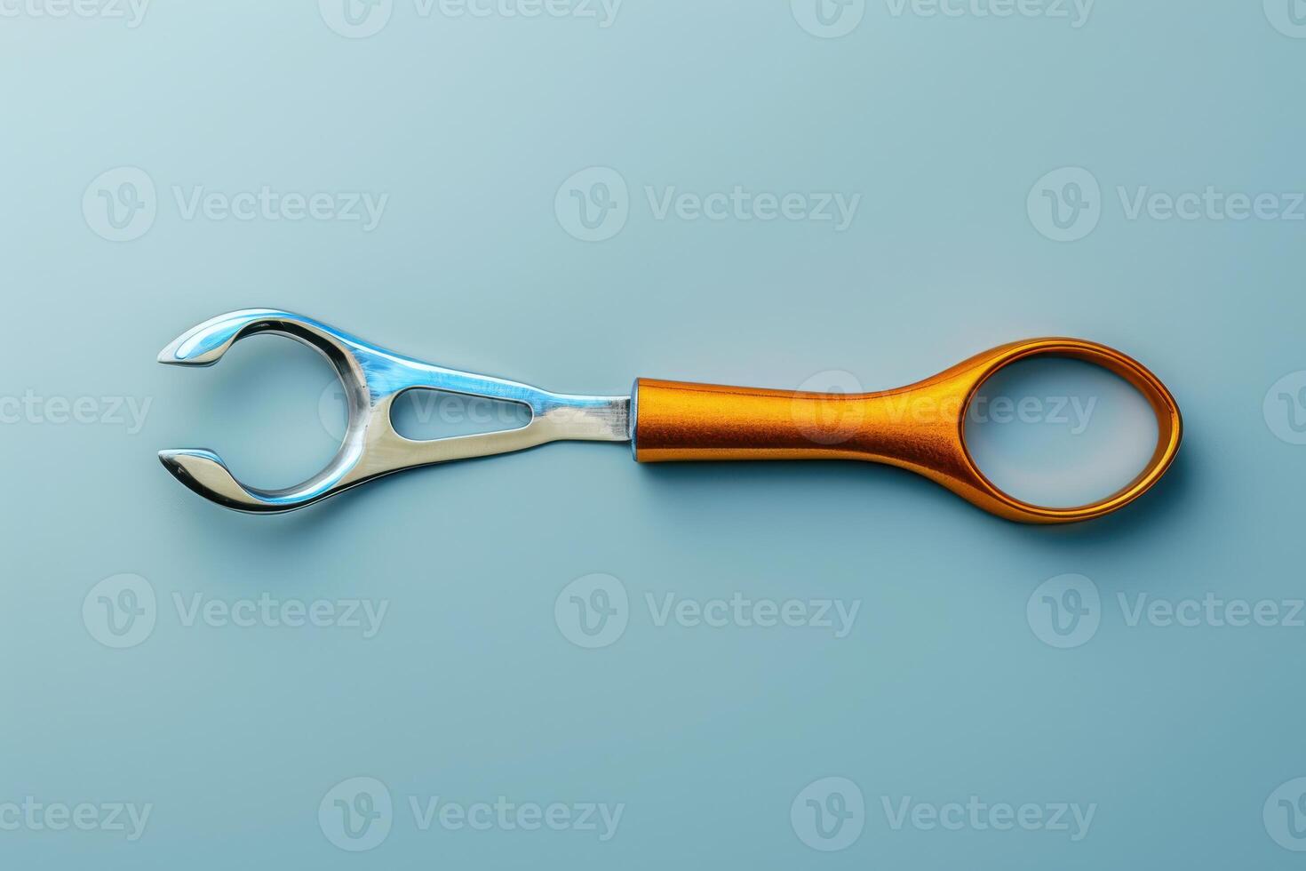 A vibrant, orange-handled tool rests against a soft blue background, showcasing its sleek design and craftsmanship, perfect for various tasks and repairs photo