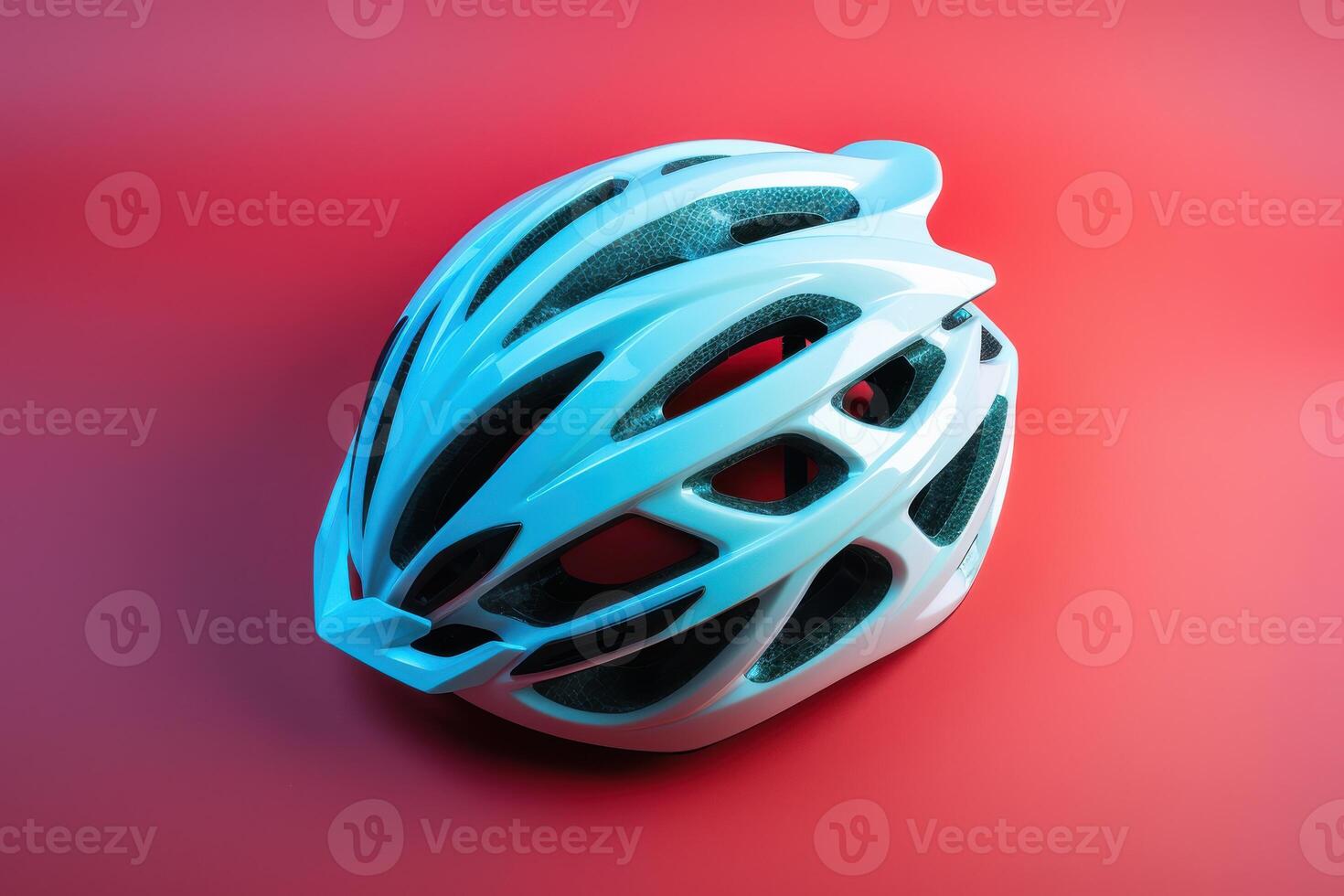 A sleek, aerodynamic cycling helmet resting on a vibrant red backdrop, showcasing modern design and safety features photo
