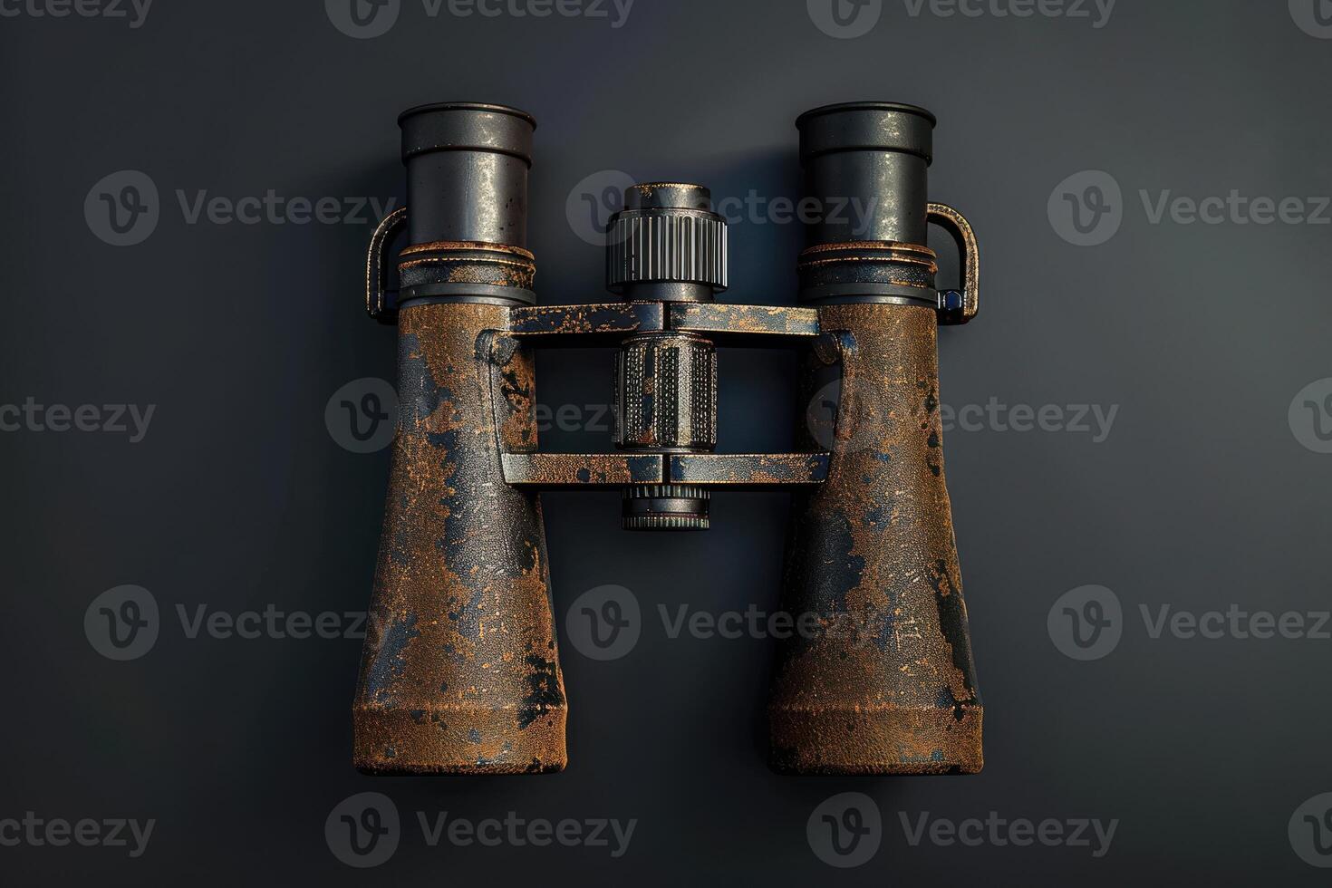 Weathered antique binoculars resting on a dark surface, showcasing their rustic charm and history photo