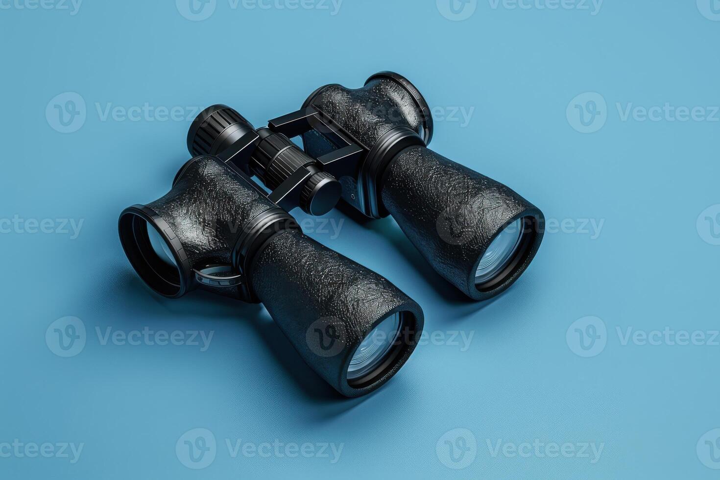Exploring distant horizons with classic binoculars on a vibrant blue backdrop photo