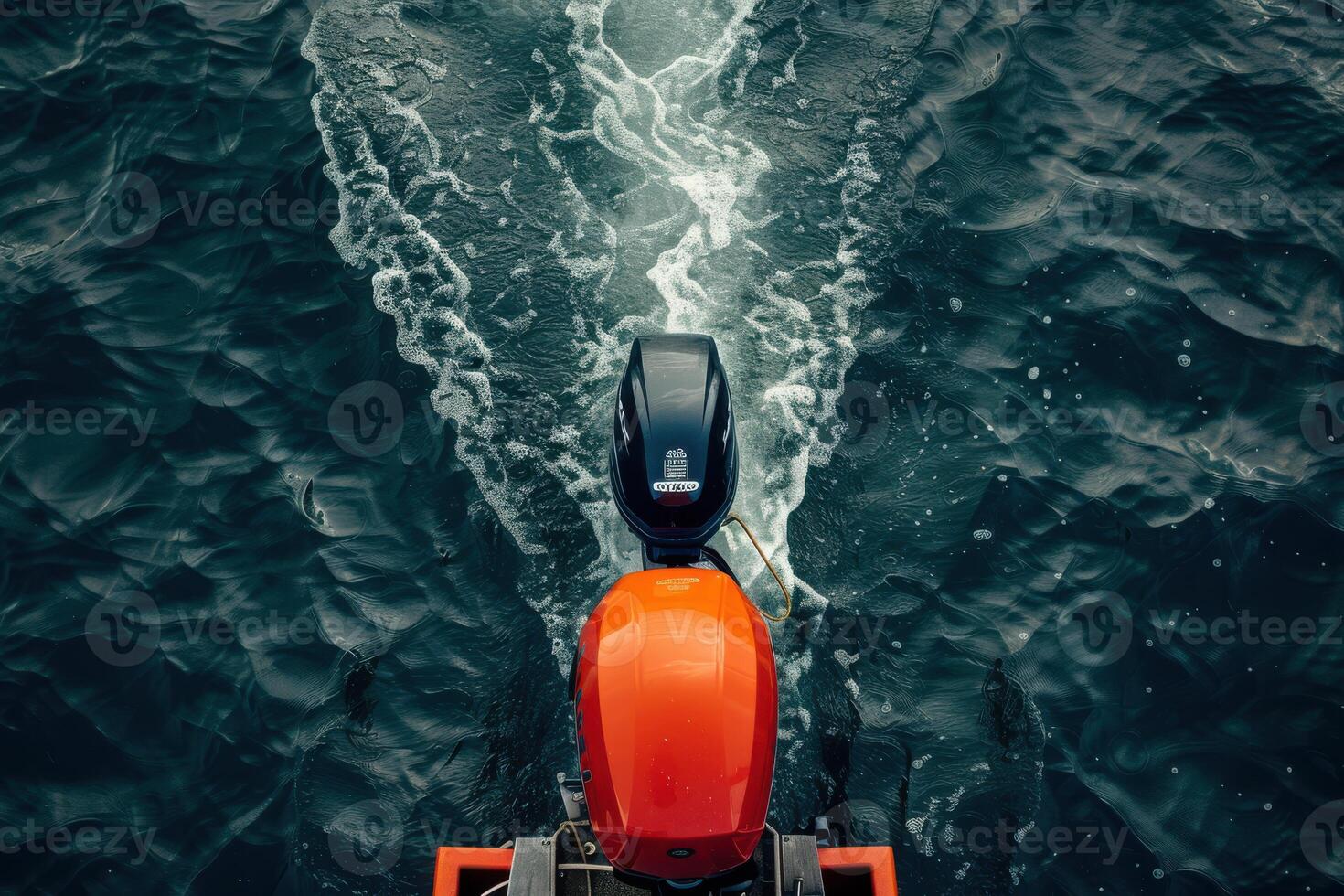 Vibrant orange motorboat gliding over deep blue water, leaving swirling wake in a serene lake during a tranquil afternoon photo