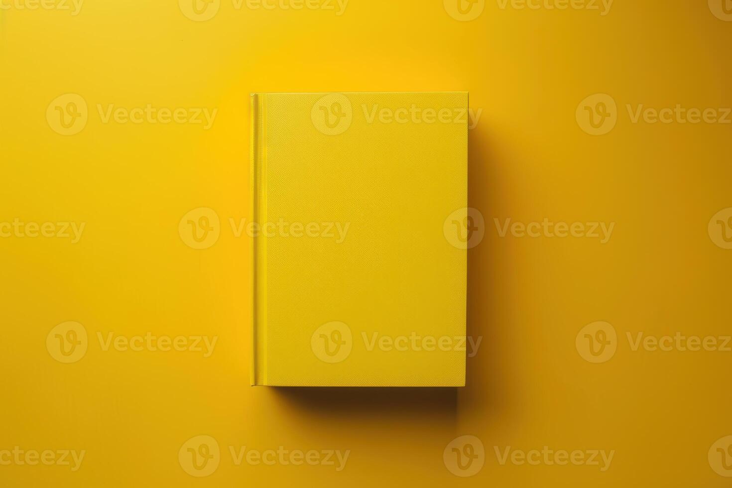 A vibrant yellow book rests on a matching backdrop, inviting curiosity and creativity in a minimalist setting photo