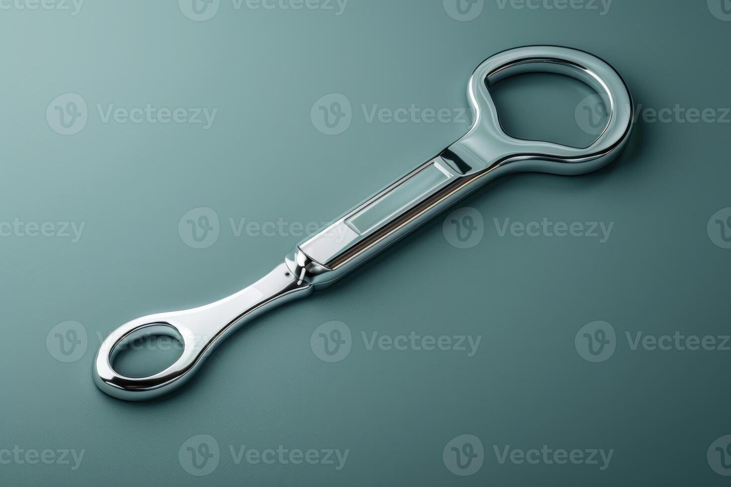 Sleek stainless steel hand tool resting on a smooth surface in soft, diffused light photo