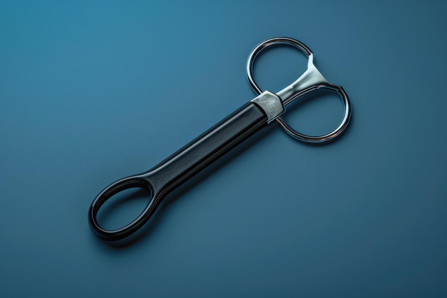 Artistic kitchen scissors resting on a blue backdrop, showcasing a sleek and modern design, perfect for culinary tasks photo