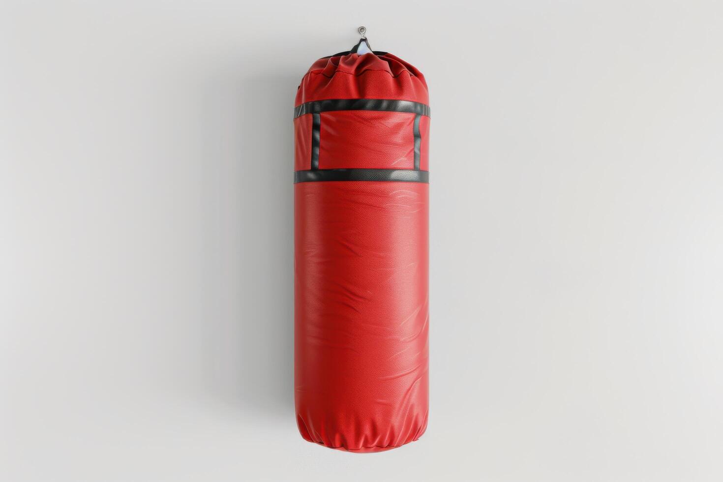 A vibrant red punching bag hanging against a clean white wall in a modern gym setting photo