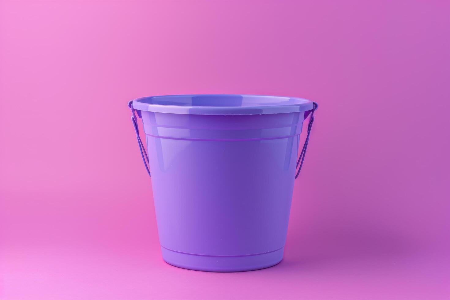 A vibrant purple bucket stands against a soft pink backdrop, casting shadows in a minimalist and playful atmosphere photo