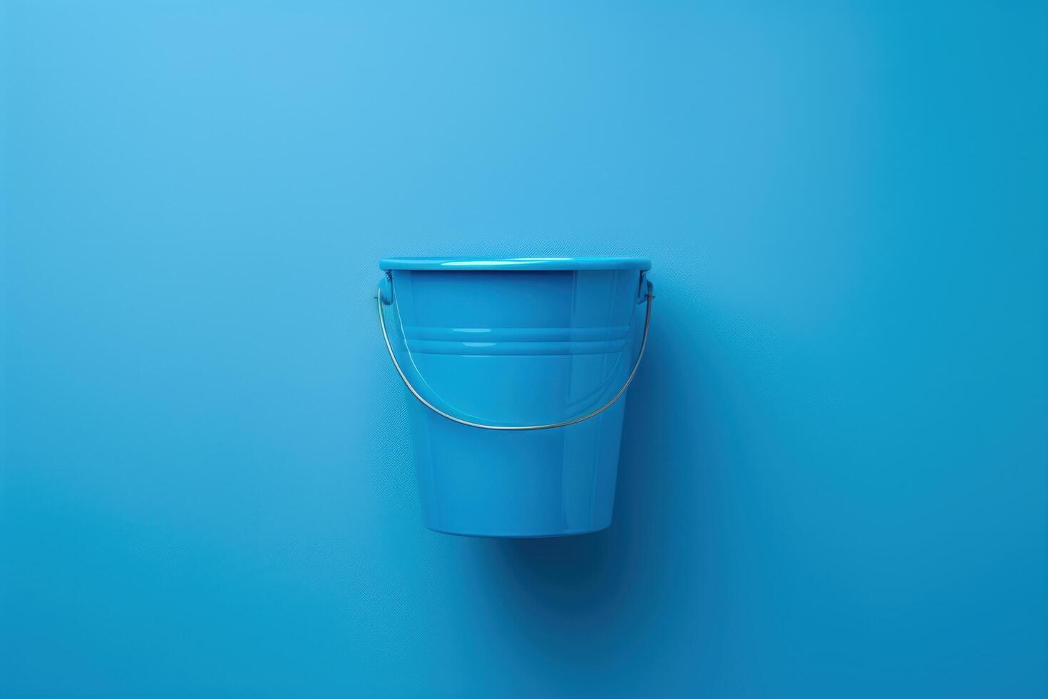 Vibrant blue bucket against a striking azure wall, capturing simplicity and color harmony in a minimalist setting photo
