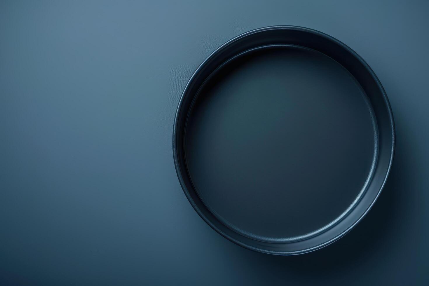 A minimalist black tray atop a textured dark surface, showcasing simplicity and elegance in modern design photo