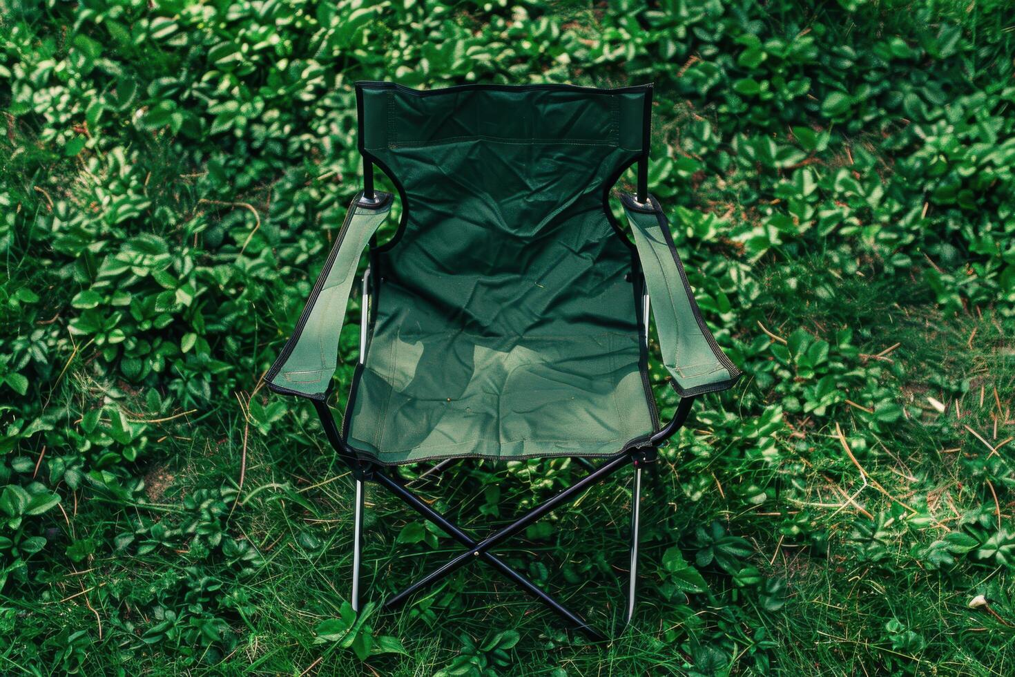 A solitary green camping chair rests on lush grass under the warm afternoon sun, inviting moments of relaxation and tranquility in nature photo