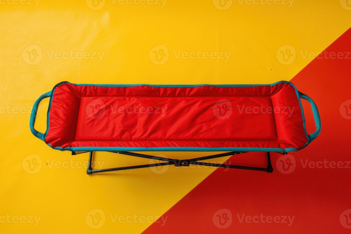 Brightly colored folding cot on a vibrant yellow and red floor photo