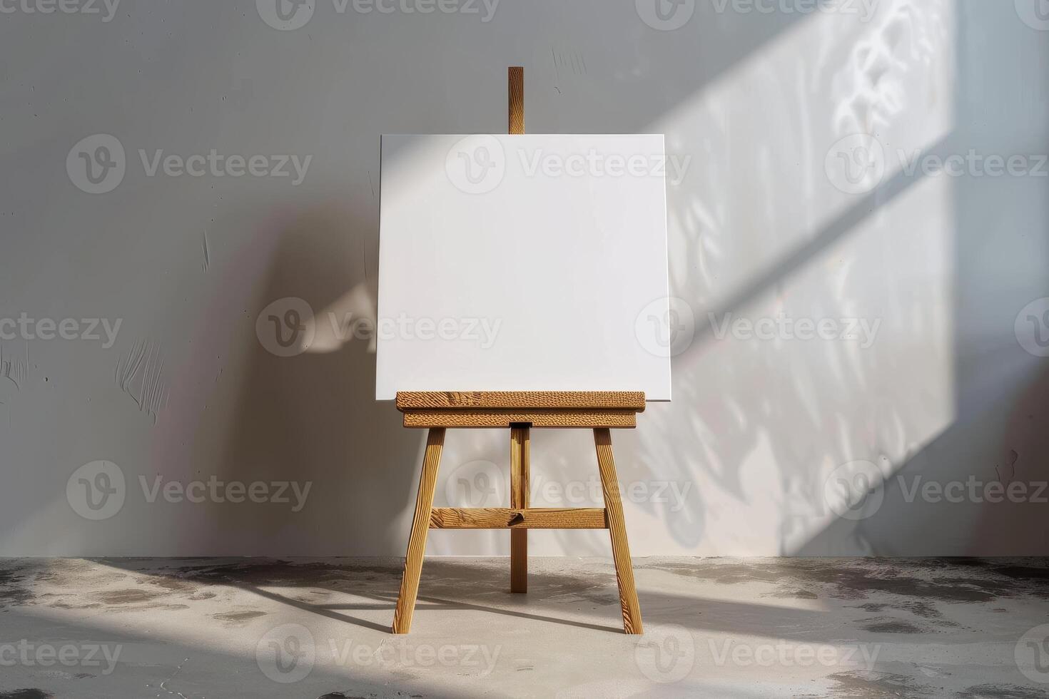 Blank canvas on easel illuminated by sunlight in a minimalistic art studio photo