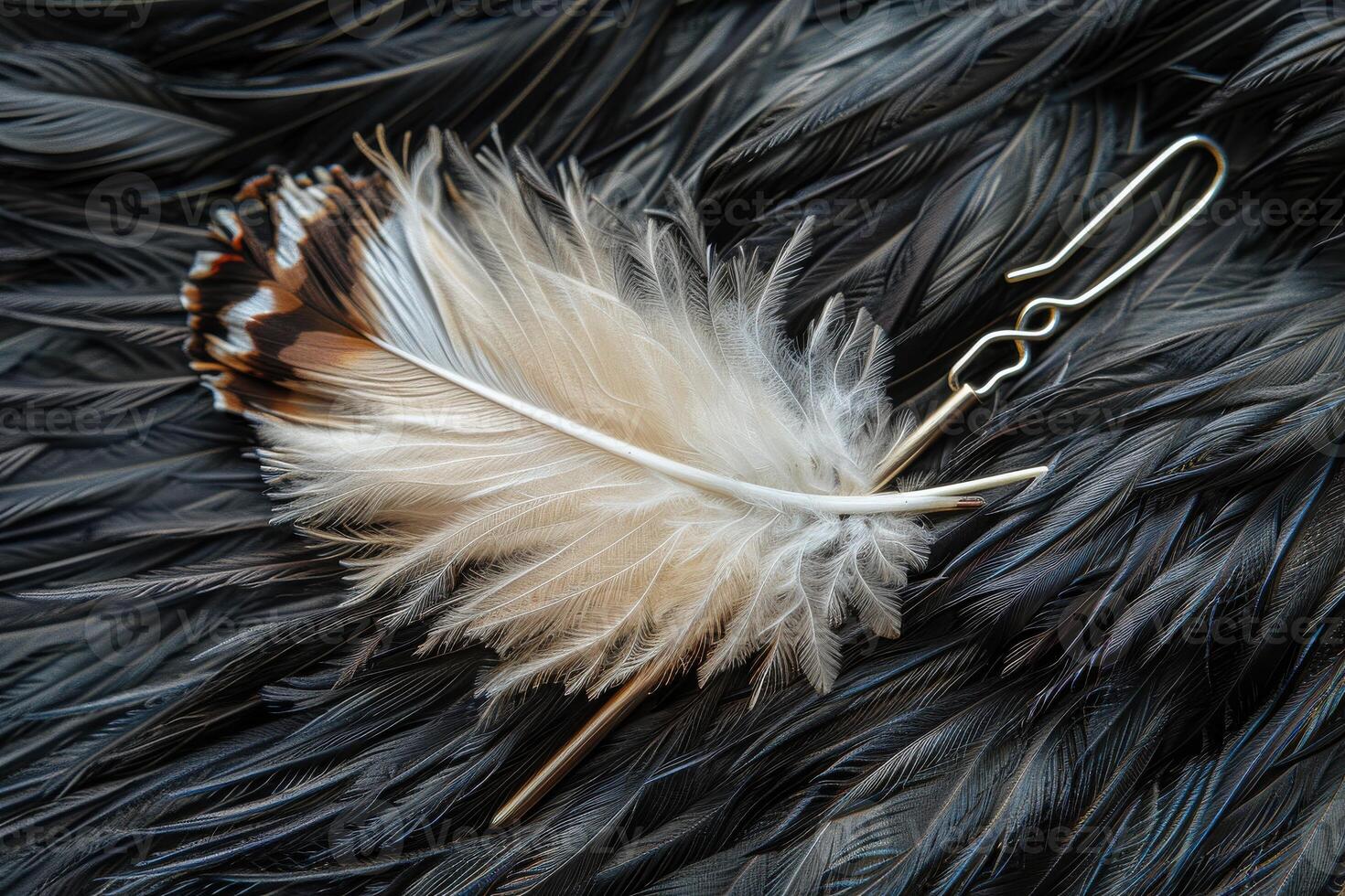 Elegant white feather hairpin resting on a dark feather background photo