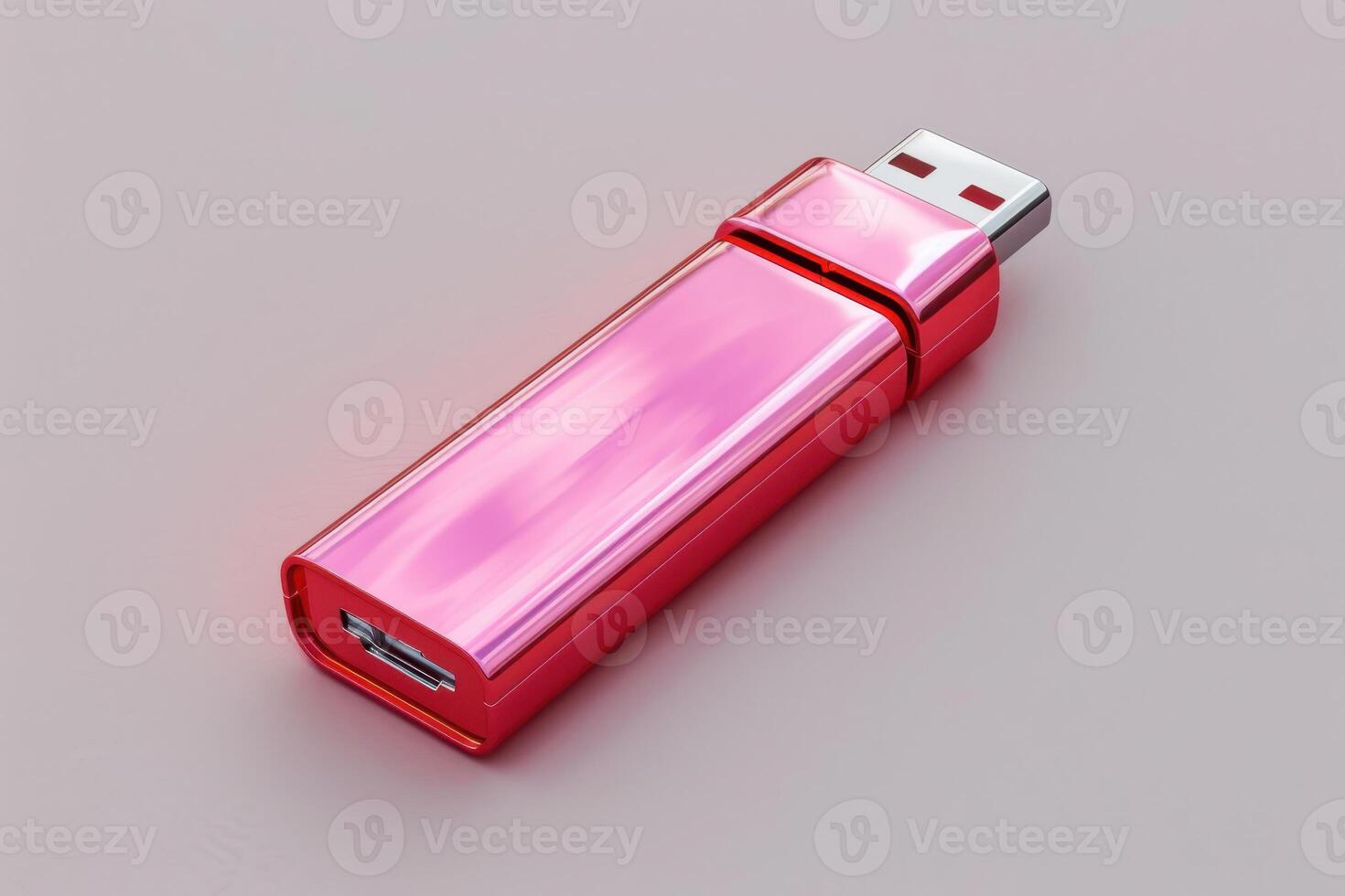 A shiny pink USB flash drive on a smooth surface with a clean design photo