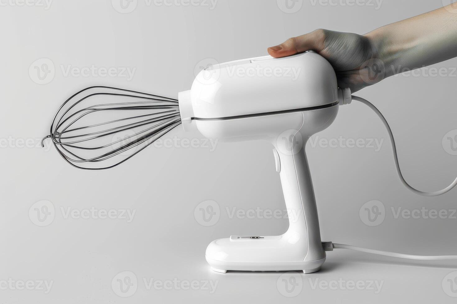 Handheld mixer in use with a white finish against a plain background photo