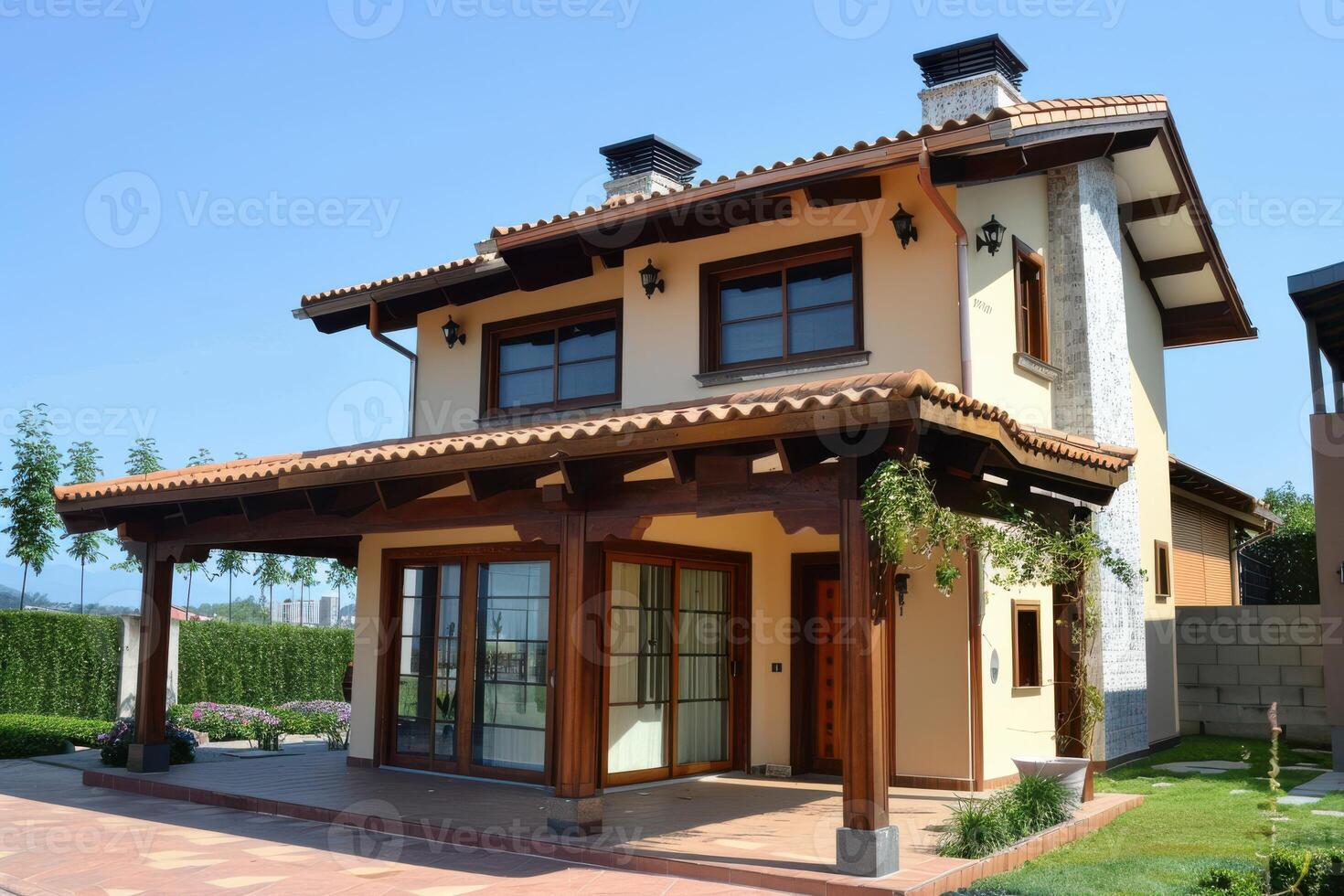 Modern two-story house with wooden accents and a manicured garden under a clear blue sky photo