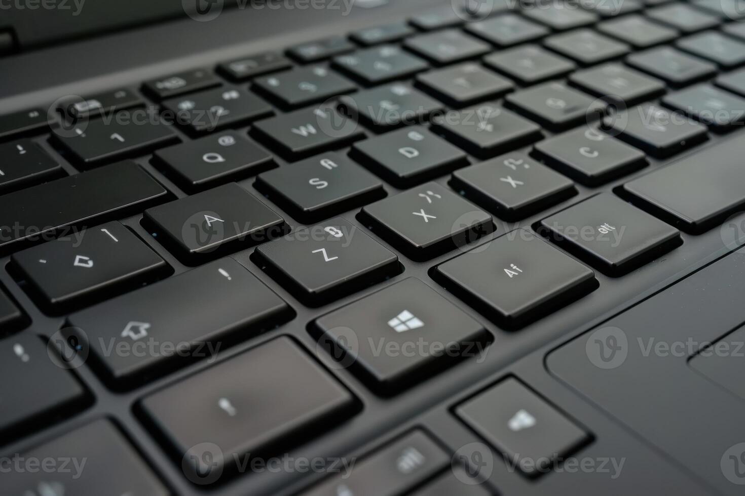 Close-up of a laptop keyboard focusing on black keys and details showing technology in use photo