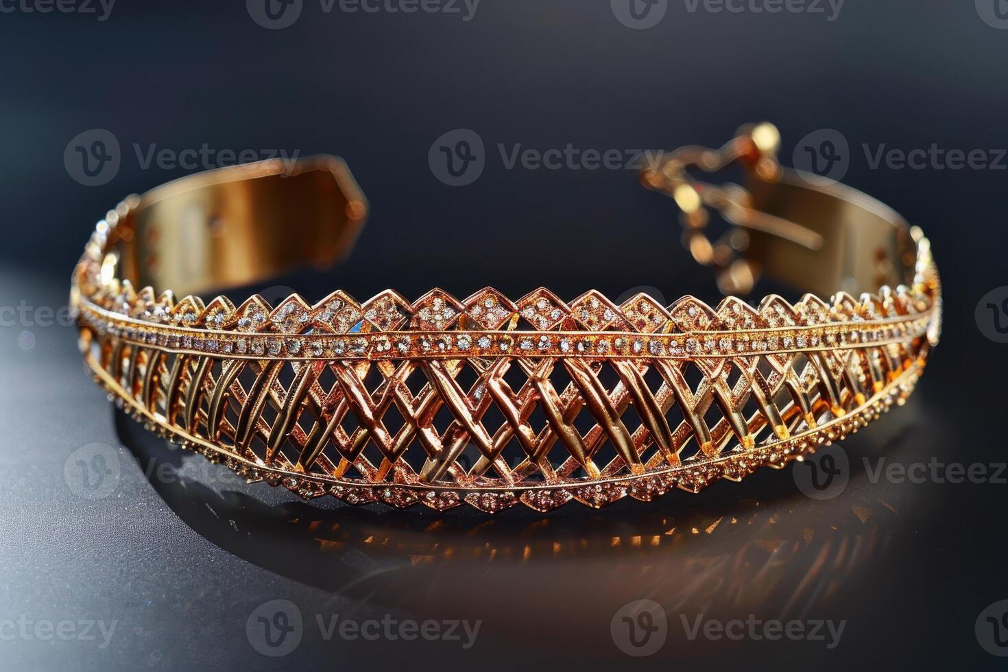 Elegant gold cuff bracelet with intricate diamond patterns displayed against a dark background photo